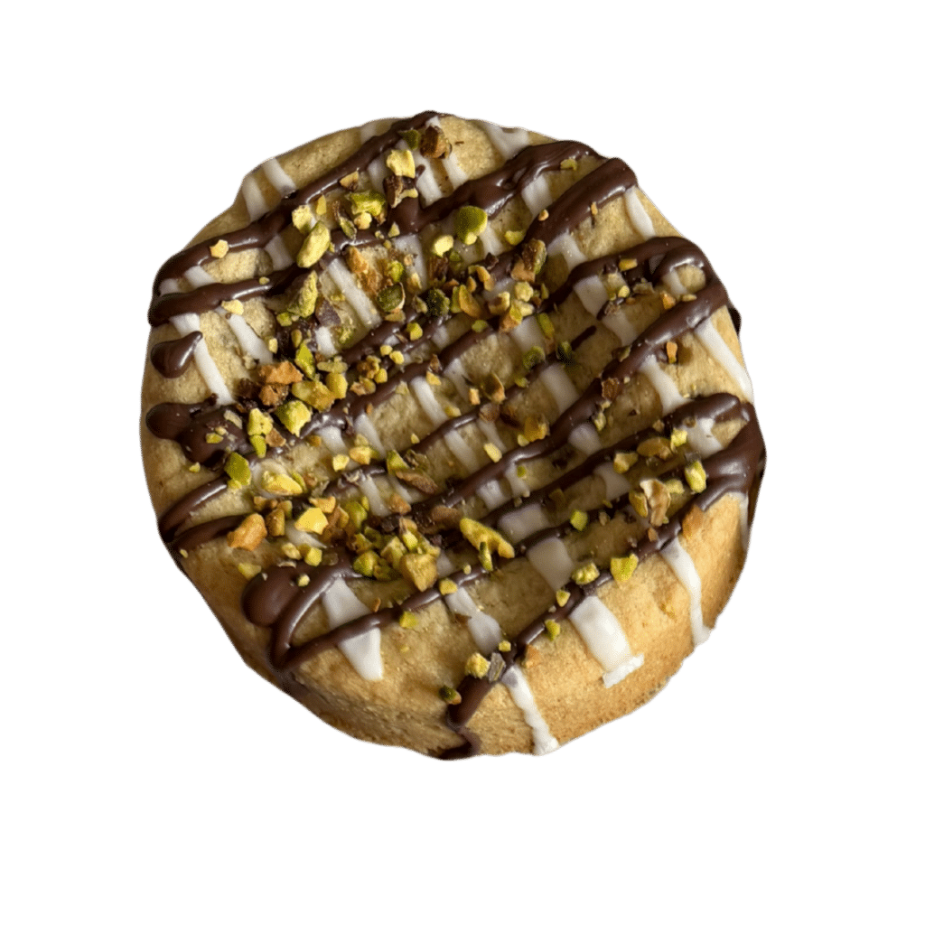 Chocolate Pistachio Bread | Gluten-Free | Coffeehouse Collection A thick, gourmet gluten-free cookie topped with a white chocolate base, a dark chocolate drizzle, and a generous sprinkle of crushed pistachios.