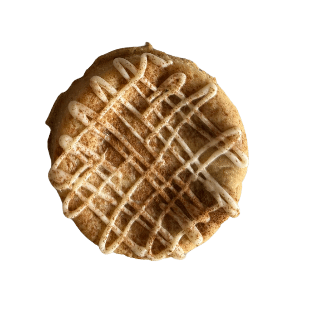 Gluten-Free Snickerdoodle with White Chocolate Drizzle A thick, soft-baked gluten-free snickerdoodle cookie topped with a heavy white chocolate cross-hatch drizzle.