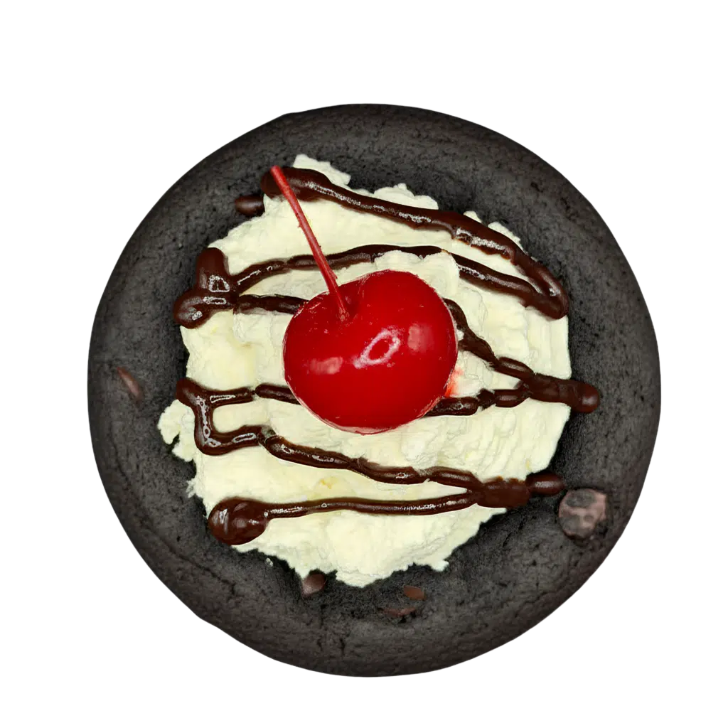 Gluten-free chocolate cookie topped with a swirl of whipped cream, chocolate drizzle, and a maraschino cherry.