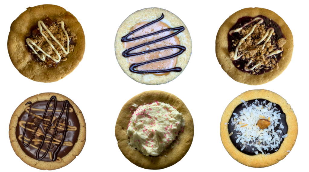 Explore this week's Featured Flourless Flavors A variety of six assorted gluten-free gourmet cookies, each featuring different toppings and flavor profiles.